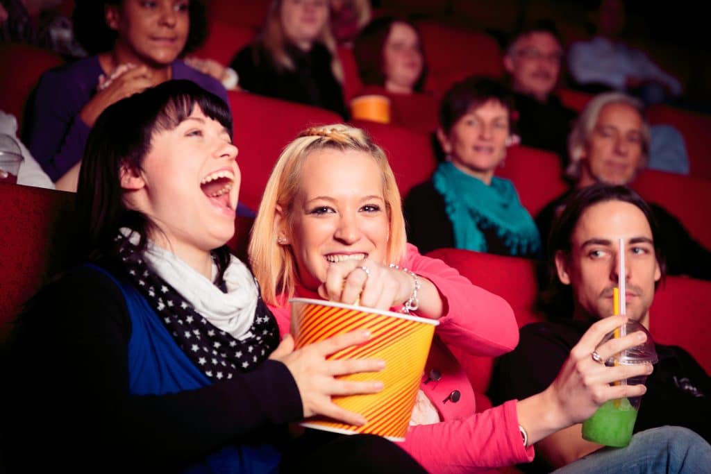 People Enjoying In Movie Theatre