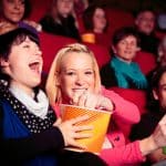 People Enjoying In Movie Theatre